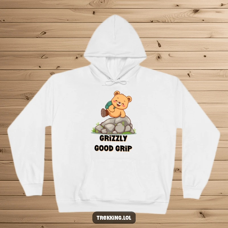 Funny bear hiking hoodie showcasing a cheerful bear in hiking boots actively climbing a mossy rock, ideal for cozy outdoor fun.