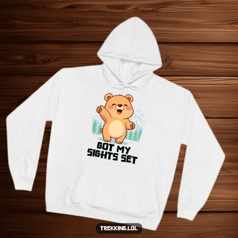 Funny hoodie featuring a smiling bear pointing enthusiastically at a distant mountain peak, evoking a sense of ambition.
