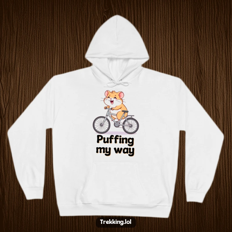 Funny Hoodie showing a giggling hamster pedaling a minuscule bicycle uphill, illustrating persistence with a humorous touch, ideal for chilly days.
