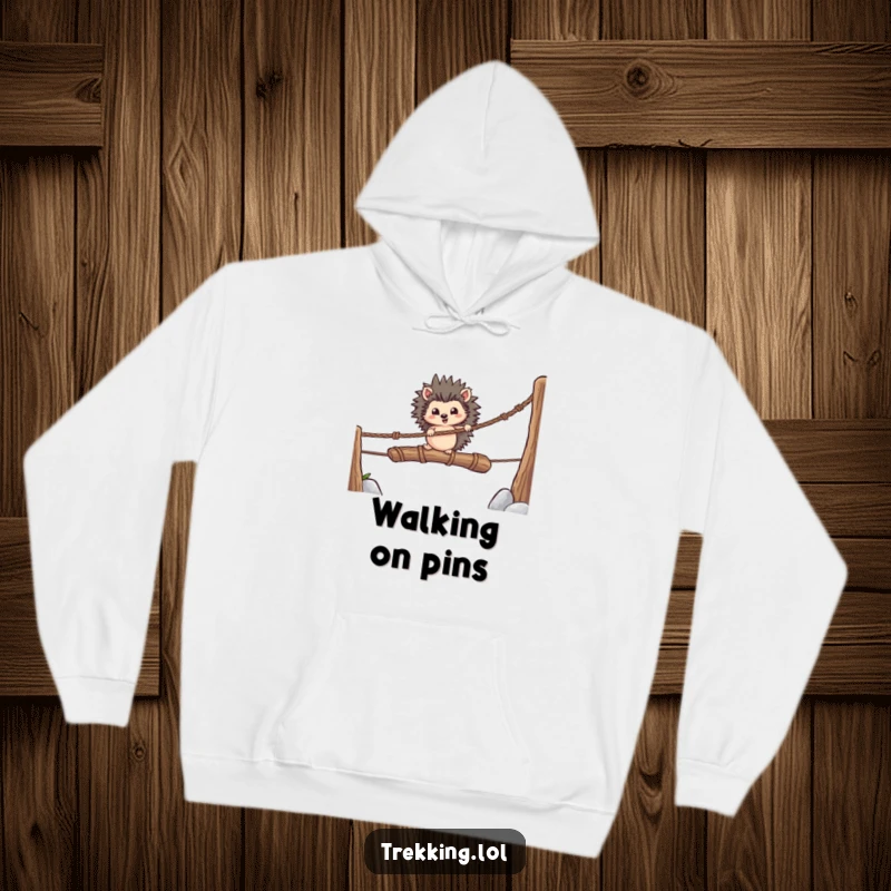 Funny hoodie featuring a brave hedgehog bravely crossing a rickety rope bridge, symbolizing courage and perseverance.
