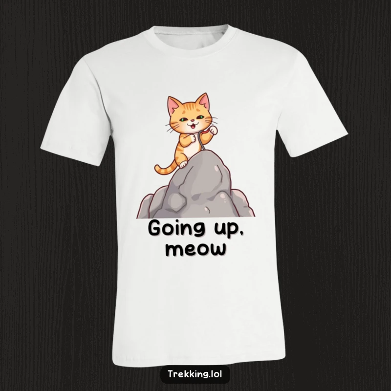 Funny t-shirt featuring a serious cat employing a miniature grappling hook to ascend a steep rock, showcasing bravery.